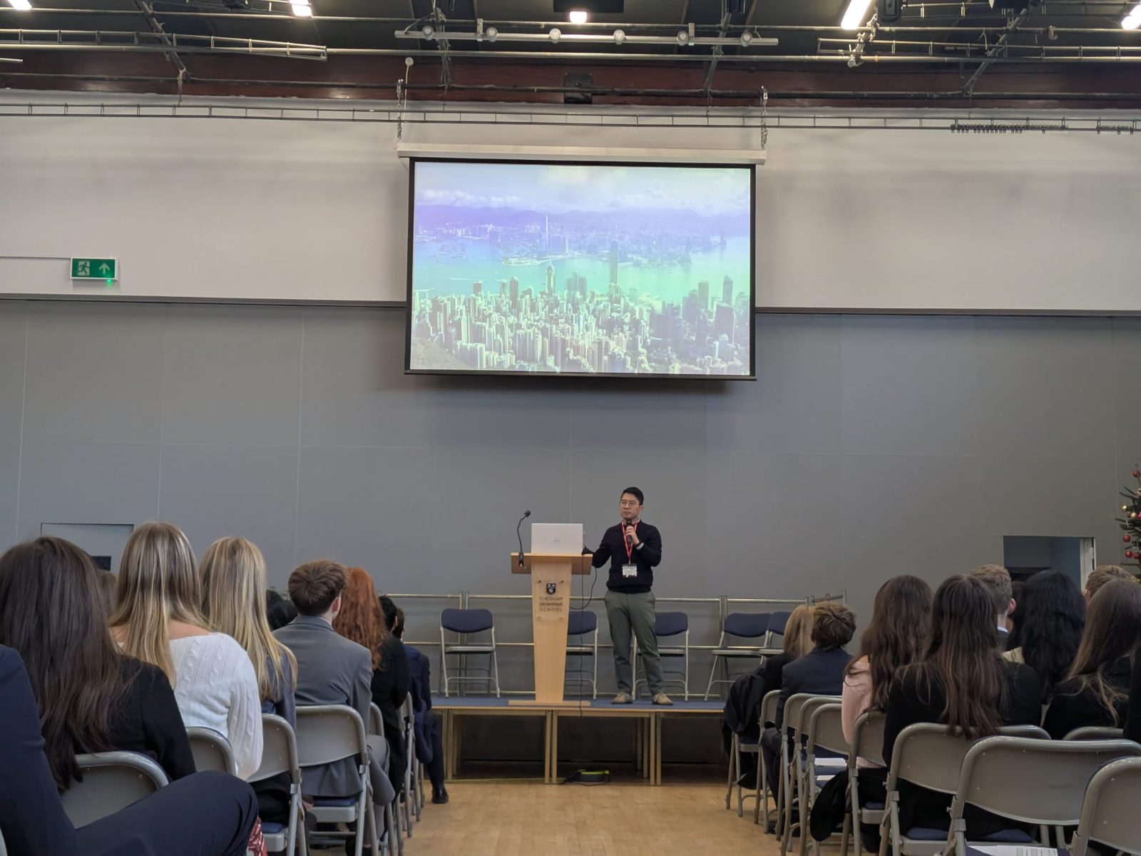 A speaker presents to students in a school hall